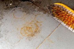 Rust stains on gray tile floors and polished yellow floors.