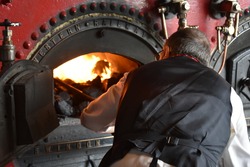 man stoking the furnace
