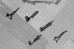 Five men in different directions, five long shadows