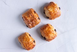 4 pieces of chocolate croissants -Home made - on white marble 