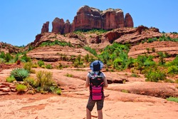 A young female Hiker deciding to hike Cathedral Rock located in Sedona Arizona. Because the girl is facing away from the camera and is wearing generic attire a model release is not necessary.