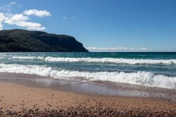 Waves on the beach at Old Woman Bay, Lake Superior Provincial Park, Ontario, Canada on a sunny day