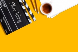 Story telling text title on movie clapper board  and coffee cup on yellow background