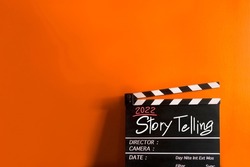 2022 story.hand writing on film slate or movie clapboard for the filmmaker.storytelling concept on multicolor background