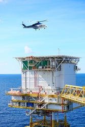 helicopter parking landing on offshore platform, Helicopter transfer crews or passenger to work in offshore oil and gas industry, air transportation for support passenger, ground service in airport.