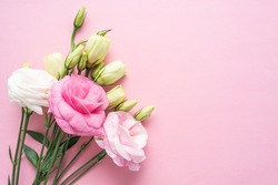 Bunch of beautiful eustoma flowers on pink background	