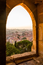 Beautiful view of Lisbon through an ancient window from the Castelo de S. Jorge, São Jorge Castle during sunset