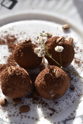 chocolate truffles decorated with coffee beans and a sprig of gypsophila