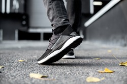 sneakers in motion, sneakers on asphalt