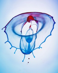 A blue and red splash on a blue background to layer, composite and blend with your own product images to add movement, color and vibrancy to your creations