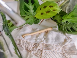 Plastic free bathroom essentials. Bamboo toothbrush and dental tabs next to a washbasin. Eco-friendly lifestyle and sustainable personal care swaps.