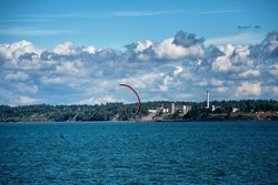 Foil Boarder Catching Wind on Bellingham Bay on Windy Day with Industrial Area on Shoreline