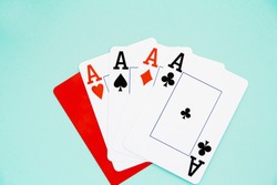 combination of four aces and red cutting card on blue isolated background.