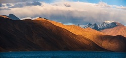 Pangong Lake world’s highest saltwater lake dyed in blue stand in stark contrast to the arid mountains surrounding it. Famous lakes in Leh Ladakh.