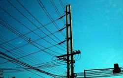 Electric pole and high voltage electric wire with blue sky use for electric supply background