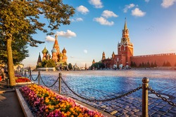 St. Basil's Cathedral and Spassky Tower on Red Square in Moscow on a summer evening and colorful flowers