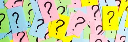 Too Many Questions. Pile of colorful paper notes with question marks. Closeup.