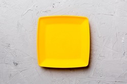 Top view of empty square plate on cement background. Empty space for your design.