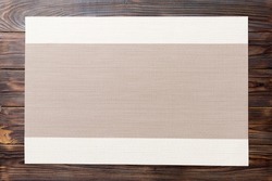 Top view of grey tablecloth for food on wooden background. Empty space for your design.