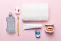 Mouthwash and other oral hygiene products on colored table top view with copy space. Flat lay. Dental hygiene. Oral care kit. Dentist concept.