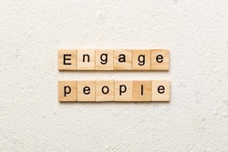 ENGAGE PEOPLE word written on wood block. ENGAGE PEOPLE text on cement table for your desing, concept.