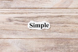 Simple of the word on paper. concept. Words of Simple on a wooden background.