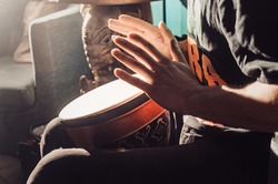 Playing the drum. Hands with a drum. another view. african, bang, beat, child, class, drum, drummer, fingers, hand, hit, instrument, kid, music, musical, percussion, play, rhythm, ring, sound.