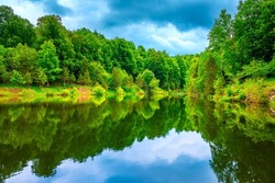 Lake landscape in spring. Summer landscape on the lake in the lush forest. beautiful reflection scene in the lake surrounded by green trees. nature background theme. Turkey's magnificent nature.