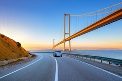 View of big highway bridge in sunny day. highway landscape in summer. Road view with big bridge in the sea. car on the road. asphalt road theme. road landscape in daylight.