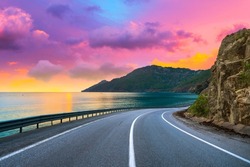 highway landscape at colorful sunset. Road view on the sea. colorful seascape with beautiful road. highway view on ocean beach. coastal road in europe. Colorful seascape in the Mediterranean.