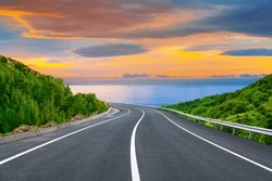 highway landscape at colorful sunset. Road view on the sea. colorful seascape with beautiful road. highway view on ocean beach. coastal road in europe. beautiful nature scenery in the mediterranean.