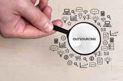 Business, technology, internet and network concept. Young businessman thinks over the steps for successful growth: Outsourcing
