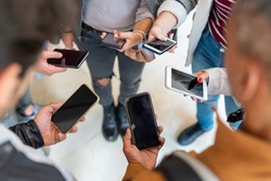 group of student holding smartphone in hands, many cellphone and people having addiction on social network and app, millennial generation behavior of social segregation