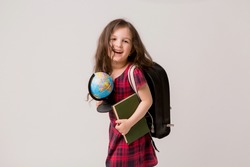 baby girl brunette in school dress with books briefcase and globe on white background,back to school