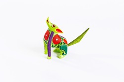 Mexican green and red alebrije from oaxaca isolated on white background. From above