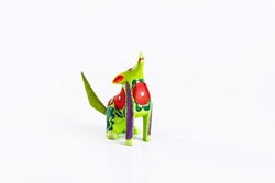 Mexican green and red alebrije from oaxaca isolated on white background.