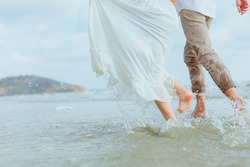 Love young couple running on the beach. Holiday and vocation concept.