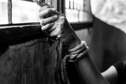 Asian young girl trafficking, kidnap or abduct Detainee tied rope at arms She get hopeless, depressed Detainee was detain and hidden by human traffickers She detain alone in room Human rights concept