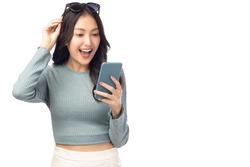 Happy and excited young woman using mobile phone standing over isolated on white background and copy space Young girl using smartphone for shopping online chat and texting message She get surprised