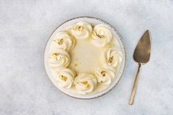 Beautiful tasty white cake with white cream; on cake stand