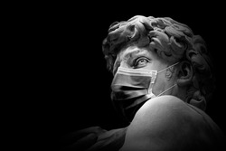 David by Michelangelo With a medical mask isolated , Renaissance sculpture created in marble