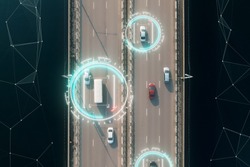 Aerial view of self driving autopilot cars driving on a highway with technology tracking them, showing speed and who is controlling the car. Visual effects clip shot.
