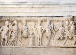 Bas-relief on stone wall of temple in Pergamon, Turkey. UNESCO world heritage site