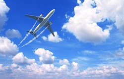 Horizontal nature background with aircraft and Jet trailing smoke in the sky. Airplane and condensation trail. Foggy trail jet and plane in blue sky with white clouds. Traveling the world concept