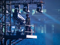 A man controls the lighting equipment. Checking stage equipment. Concert equipment. Director of the world.