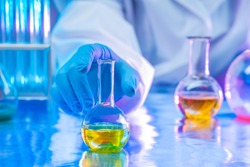 Chemical research. The chemist observes the chemical reaction in the solution. Analytical chemistry. Reagents for the laboratory. Laboratory test. Medical expertise.