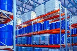 Chemical storage warehouse. Containers for chemical liquids. Warehouse system. Toxic barrels are kept in stock. Warehouse storage. Chemical Industry. Plastic barrels of chemicals are on pallets. 