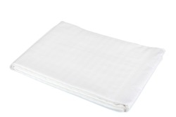 White bedsheet cover when folded. Synthetic bedsheet cover on a white background. Linens. Snow-white bedsheet close-up. Blonde fabric blanket. Production of bed linen. Production of bedding. Textile