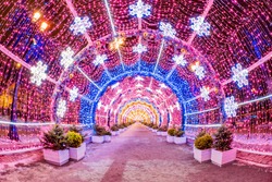 Moscow. Russia. Tunnel of Christmas garlands. A long tunnel of glowing garlands. New Year's illumination on the streets of Moscow. Snow. Walks in the winter capital. Tour of Russian cities.