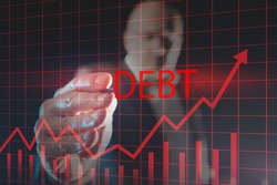 Debt growth graph on a virtual screen. Financier draws a rating for debt obligations. Concept -  growth of public debt. Ìan with a stylus in background. Economy. Financial market. Credit liabilities